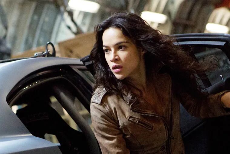 This film publicity image released by Universal Pictures shows Michelle Rodriguez in a scene from "Fast & Furious 6." (AP Photo/Universal Pictures, Giles Keyte)