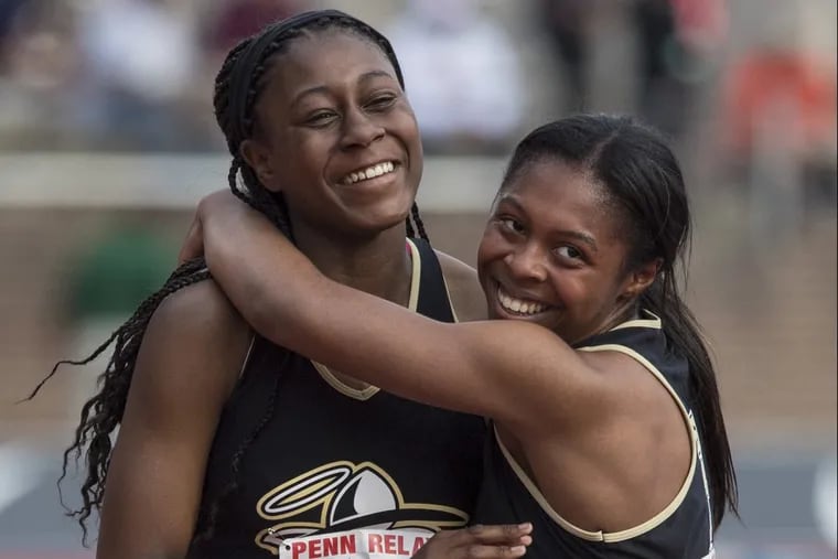 Neumann-Goretti’s Arianna Ruffin (right) hugs anchor Sydni Townsend after they won the 4×400 relays at last year’s Philadelphia Catholic League championship race at the Penn Relays.