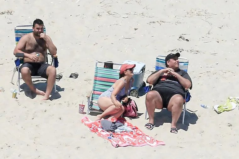 Gov. Chris Christie (right) and his wife Mary Pat enjoy a picture perfect Sunday afternoon at the beach on Island Beach State Park, which is closed to the public due to the state government shutdown.
