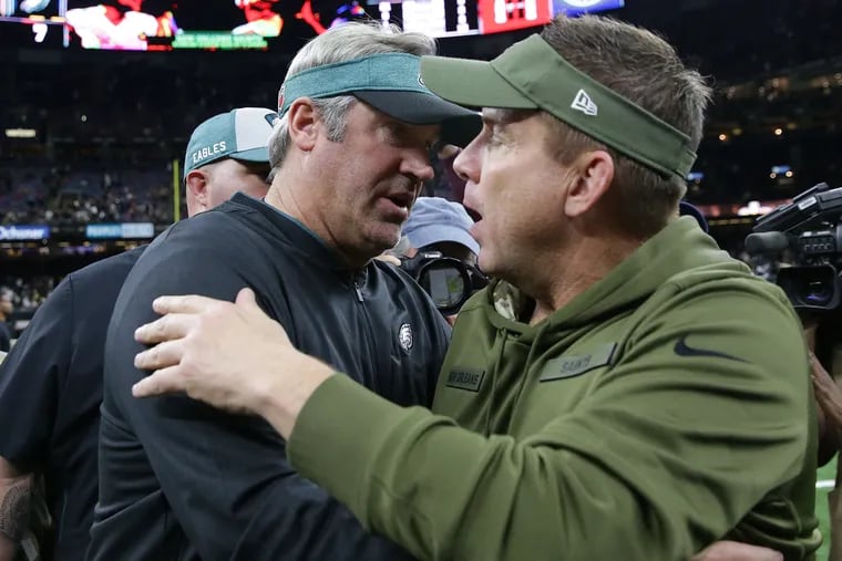 Eagles coach Doug Pederson, left, and Saints coach Sean Payton embrace after the game.