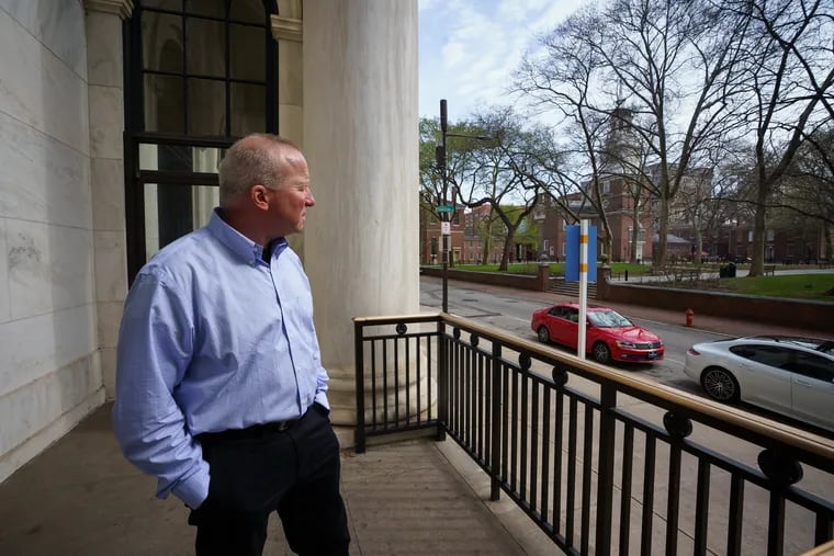 Ken Sher outside his apartment in the Curtis Building, near the Independence Hall clock tower and traffic, which contribute to noise in Philadelphia.