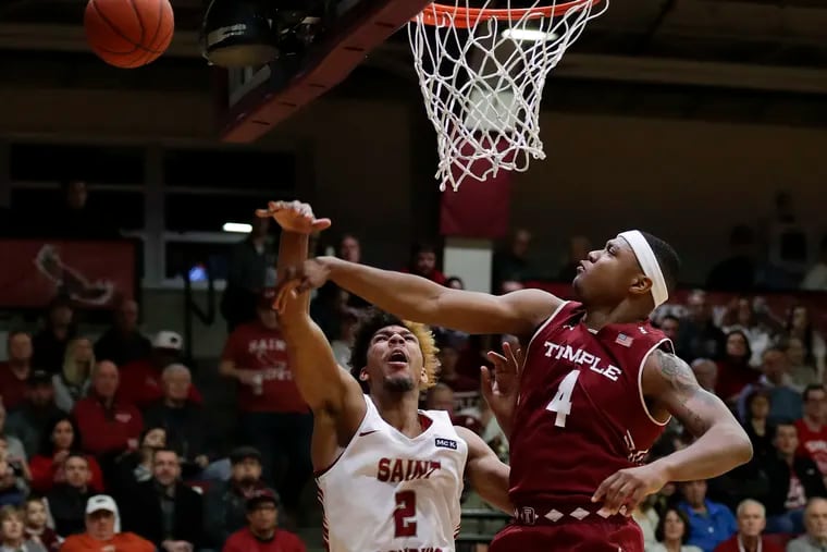 Saint Joseph's forward Charlie Brown Jr., gets his shot attempt blocked by Temple forward J.P. Moorman II during the first-half on Saturday, December 1, 2018.  YONG KIM / Staff Photographer