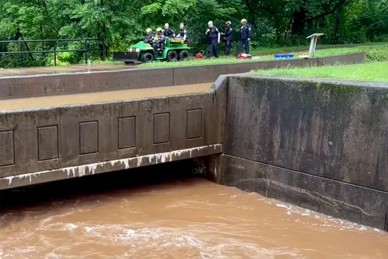 After fatal flash flooding on Saturday, members of Pennsylvania Task Force 1 drove out the body of a person after recovery in it the woods between the Delaware Canal towpath and Delaware River near Houghs Creek in Upper Makefield.