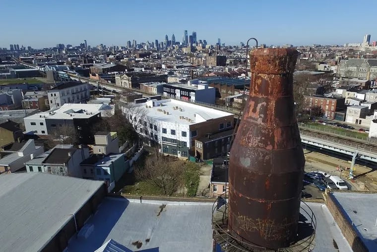 The iconic milk bottle water tower atop the former Harbison’s Dairy in Kensington has been given historic designation by the city.