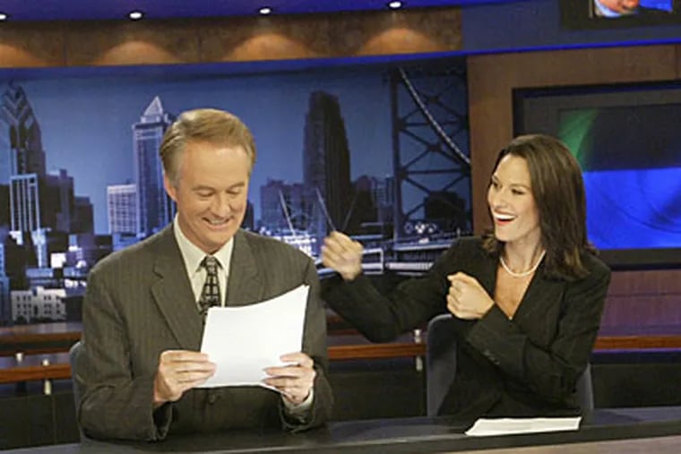 Alycia Lane jokes with co-anchor Larry Mendte when the two were a top newscast duo in 2003.  Mendte is now suing two newspapers, claiming defamation.