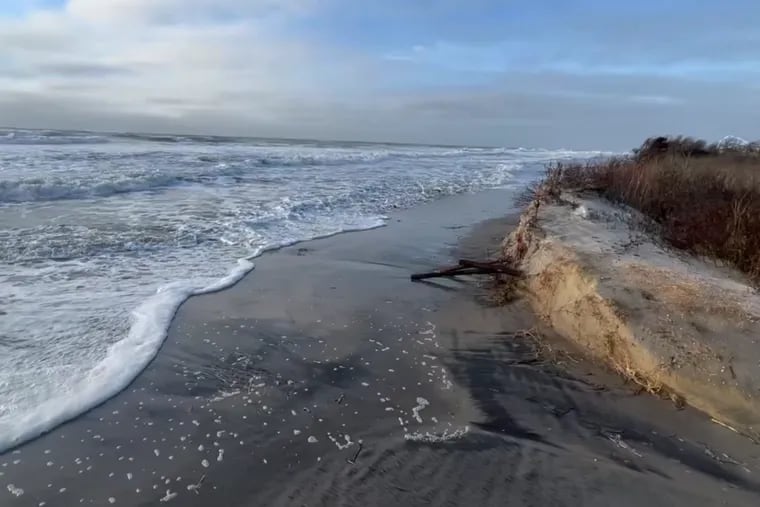 Waves from a storm surge crash along the dunes of 14th Avenue Beach in North Wildwood, N.J. In recent years, North Wildwood has spent millions of dollars to truck in sand from Wildwood almost daily during the summer to combat erosion.