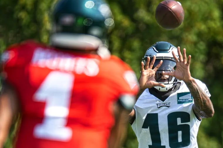 Eagles quarterback Jalen Hurts throws the ball to Quez Watkins during a recent practice on at the NovaCare Complex. Watkins who could see more action in place of the injured A.J. Brown says he's "ready for the opportunity."