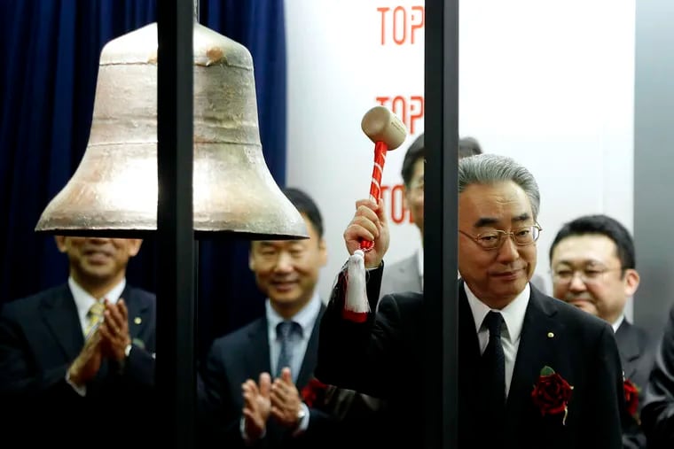 Satoshi Fujisawa, president and chief executive officer of Ashikaga Holdings Co., hits a bell during an initial public offering ceremony for the company's relisting on the Tokyo Stock Exchange. Regional lender Ashikaga, one of four companies debuting on Japanese exchanges, opened 7.4 percent higher than its IPO price.