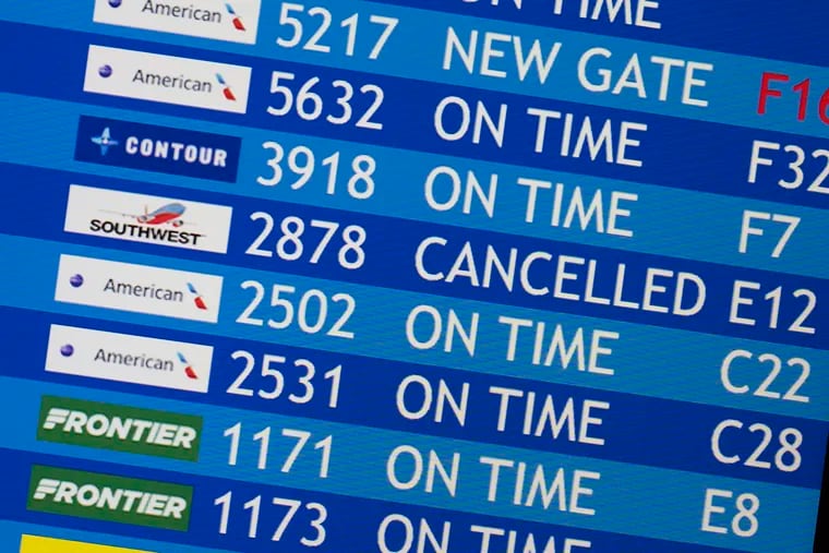 A flight information airport display board shows a Southwest cancellation on Tuesday at Philadelphia International Airport.