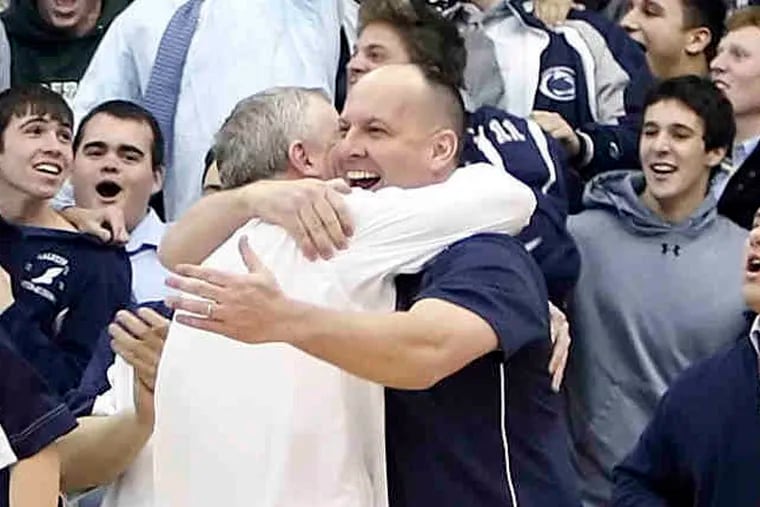 Malvern Prep's head coach Jim Rullo, dark shirt hugs assistant coach Rick Colvin, white shirt as the clock runs out on Episcopal Academy beating them 48-43 and clinching the Inter-Ac title in Newtown Square, Pa.. Tuesday, February 8, 2011 ( Steven M. Falk / Staff Photographer )