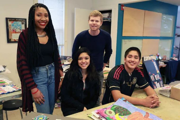 Art teacher Robert Kelleher helped students including Chinyere Nwanosike (left), Jenniffer Lopez, and Julio Ramos design the 24 stained-glass-style ornaments. (David Swanson / Staff Photographer)
