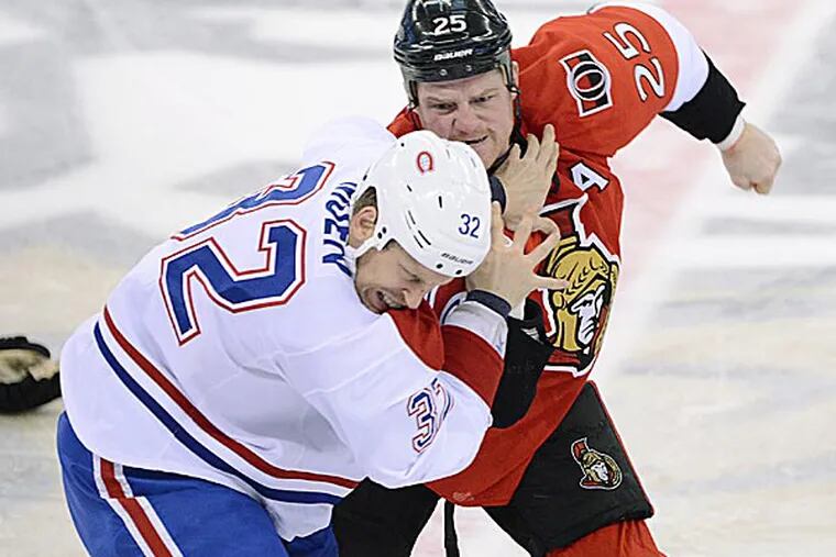 The Senators' Chris Neil fights with the Canadiens' Travis Moen in the first period. (Sean Kilpatrick/The Canadian Press/AP)