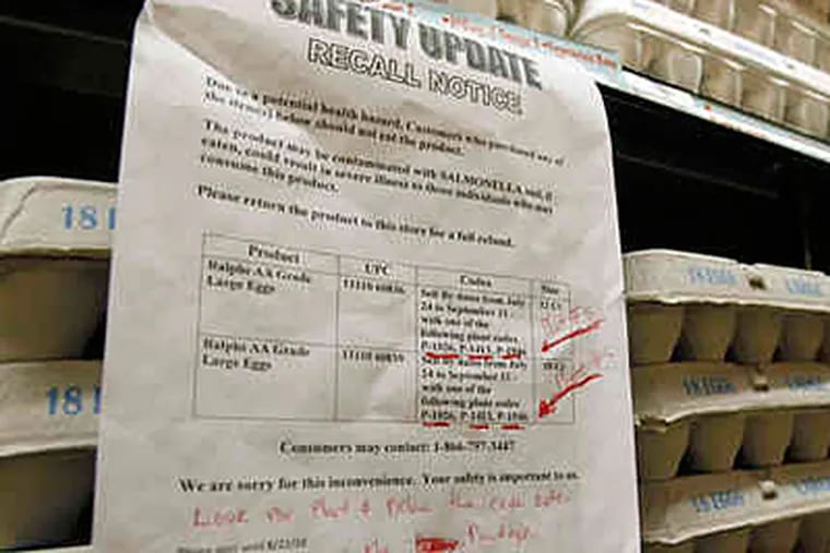 A sign warns customers of the recall of certain lots of eggs sold at a supermarket in Los Angeles. (REED SAXON / Associated Press)