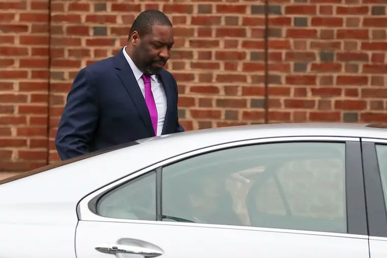 Philadelphia City Councilmember Kenyatta Johnson walks to a car with his wife, Dawn Chavous, outside the federal courthouse in Center City on Thursday.