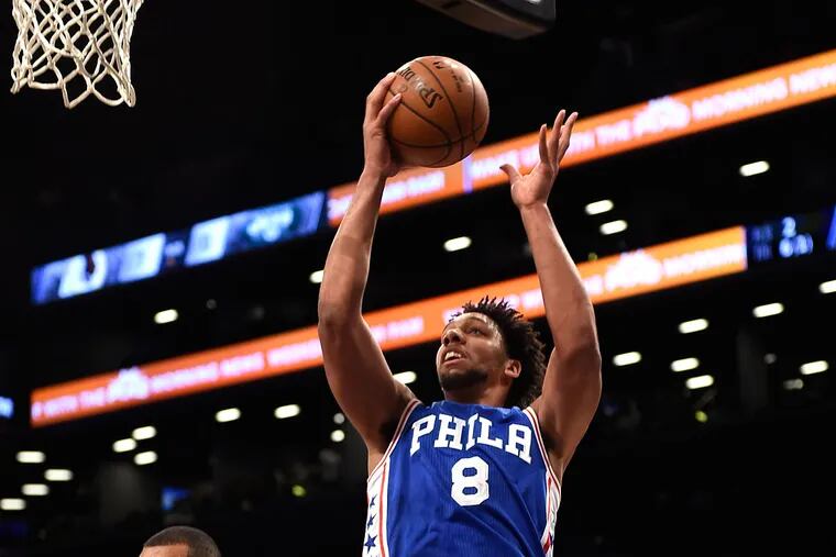 Philadelphia 76ers center Jahlil Okafor (8) drives to the basket over
Brooklyn Nets guard Wayne Ellington (21) during the first half of an NBA preseason basketball game on Sunday, Oct. 18, 2015, in New York.