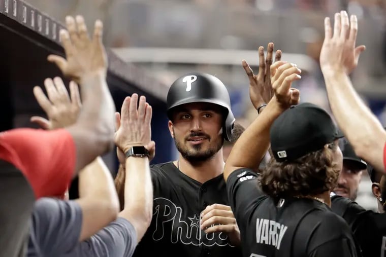 Zach Eflin is congratulated after scoring on a bases-loaded walk by J.T. Realmuto in the fourth inning Saturday night.