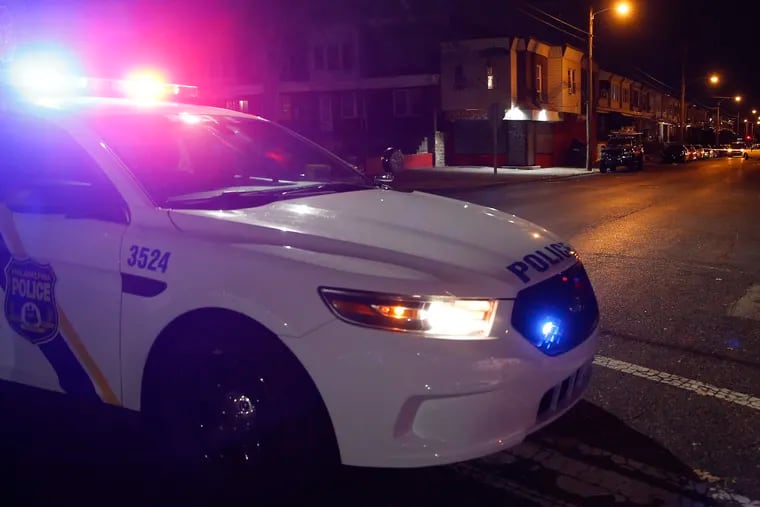 A Philadelphia Police cruiser stands guard in Olney after a shooting last month.