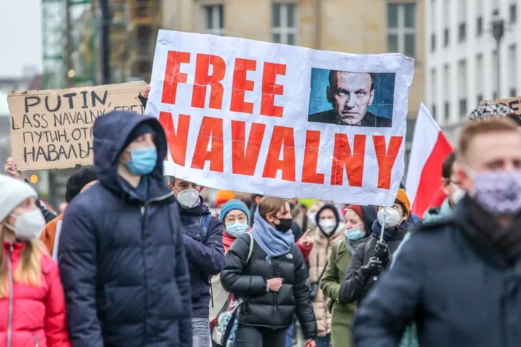 Protesters hold a banner reading "FREE NAVALNY" as some 2,500 supporters of Russian opposition politician Alexei Navalny march in protest to demand his release from prison in Moscow on Jan. 23 in Berlin.