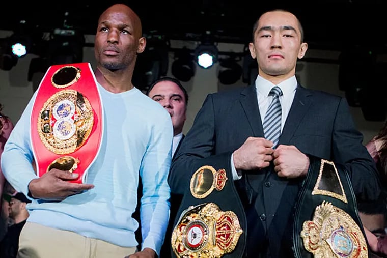 IBF light heavyweight boxing champion Bernard Hopkins, left, and WBA and IBA light heavyweight boxing champion Beibut Shumenov, right, of Kazakhstan, pose with their championship belts during a news conference in Washington, Thursday, April 17, 2014, about their 175-pound unification fight to be held at the DC Armory in Washington on April 19. (Manuel Balce Ceneta/AP)