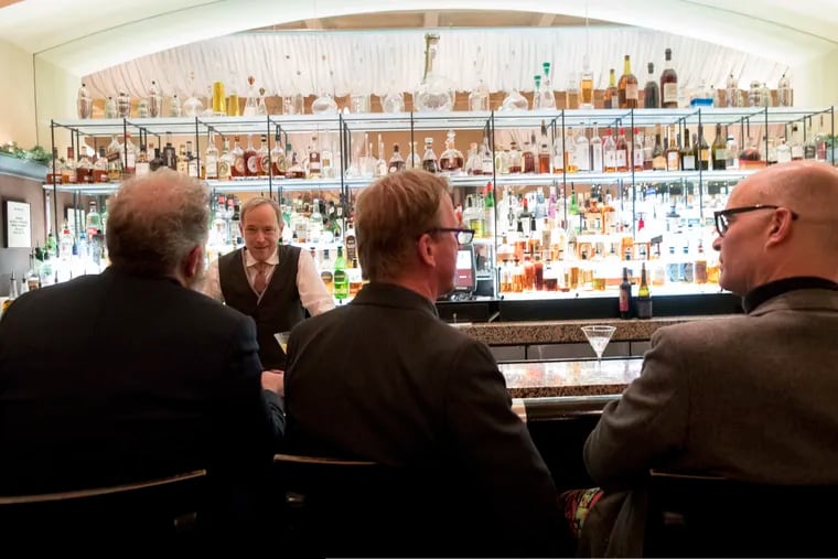 This November 2018 photo shows a bartender talking to a customer at the Gotham Bar and Grill in New York. The Manhattan upscale restaurant hopes to reopen by the summer.