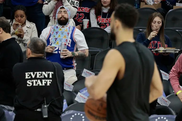 A Sixers fan dressed as a baby greets Brooklyn Nets player and former Sixer Ben Simmons (in foreground) during warmups before the Nets played the 76ers at the Wells Fargo Center in Philadelphia on Thursday This is the first meeting of the two teams since former Sixers Ben Simmons, Seth Curry and Andre Drummond were traded for James Harden.