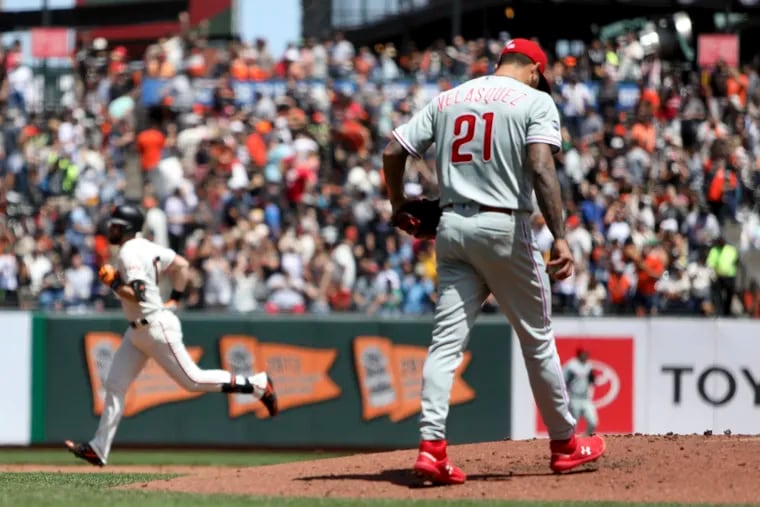 San Francisco Giants' Evan Longoria, back left, rounds the bases after hitting a two-run home run off Philadelphia Phillies' Vince Velasquez (21) in the second inning of a baseball game in San Francisco, Saturday, Aug. 10, 2019. (AP Photo/Scot Tucker)