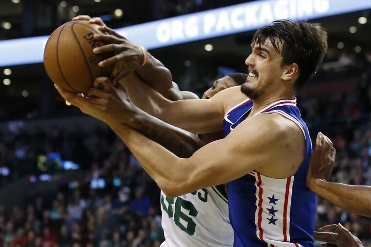 Sixers’ forward Dario Saric fights for the ball against Celtics’ guard Marcus Smart during the second quarter of the Sixers’ loss on Thursday.
