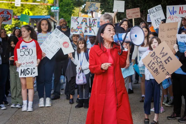 Helen Gym, candidate for mayor of Philadelphia, speaks to those gathered outside Masterman in a protest against changes at the school that would result in many students no longer having art and music.