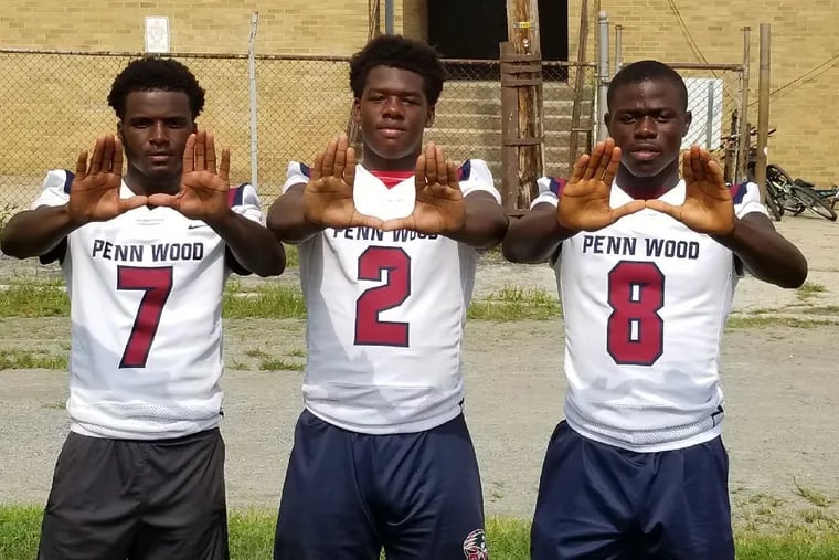 Penn Wood players, from left to right, Kennedy Poles, Desman Johnson, and Edmund Dennis.