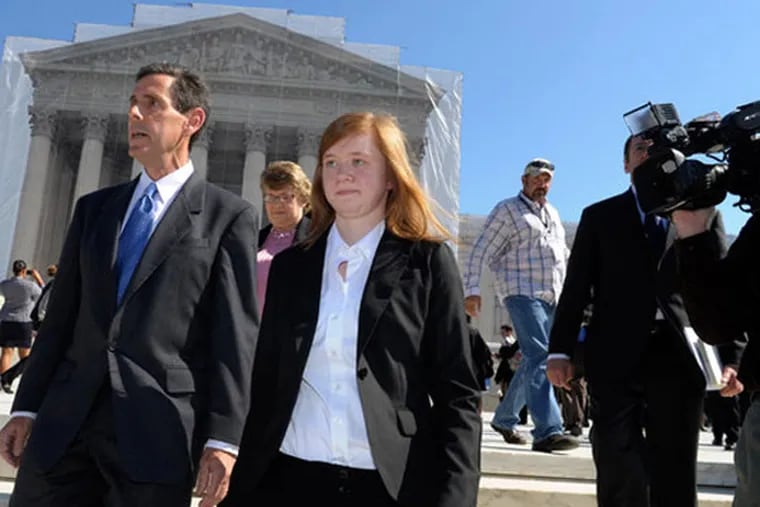 Abigail Fisher and Edward Blum walk outside the Supreme Court in October 2012. (Susan Walsh/AP)