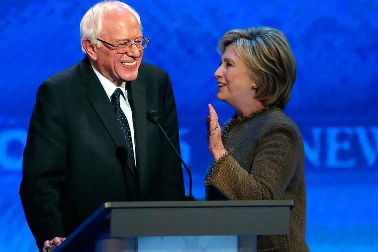 Bernie Sanders and Hillary Clinton chat during a break at a New Hampshire debate in December.