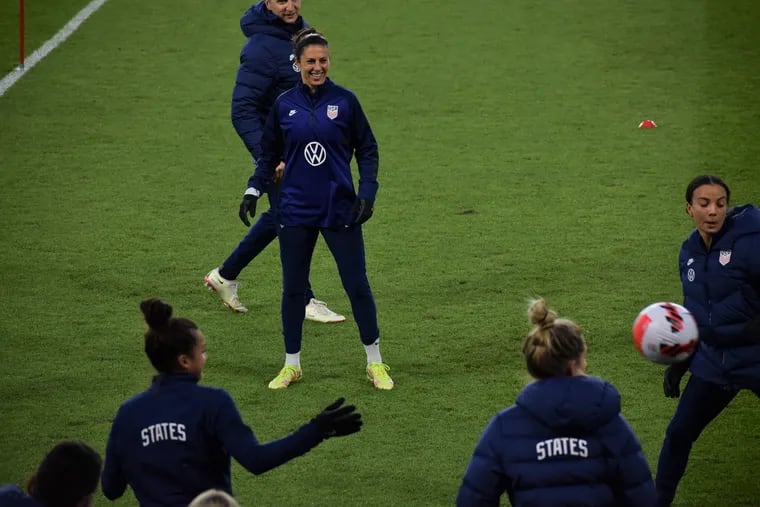 Carli Lloyd (center) smiles as she watches her teammates during the U.S. women's soccer team's practice session Monday evening at Allianz Field in St. Paul, Minn.