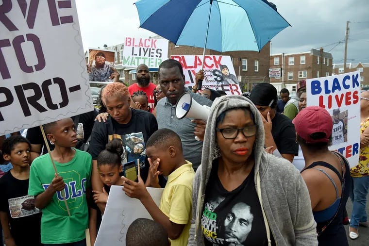 Doretha Crosby (center, left) the mother of David Jones, joins friends and family in a protest outside headquarters of the 15th Police District on June 19, 2017. Jones was fatally shot June 8, 2017, by Philadelphia Police Officer Ryan Pownall, a 12-year veteran assigned to the 15th District. With bullhorn is Asa Khalif with Black Lives Matter Pennsylvania. 