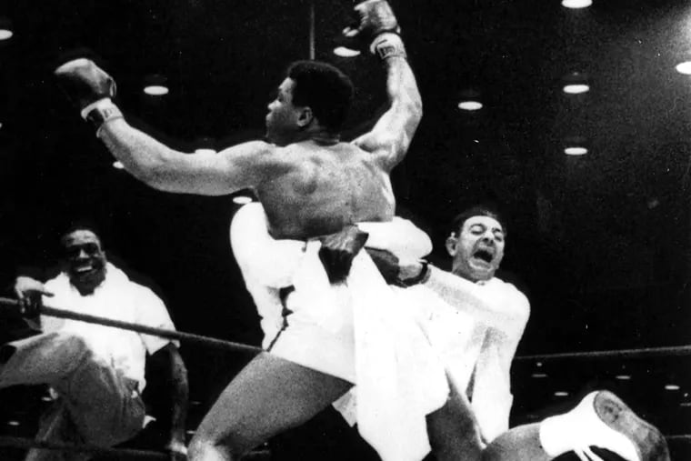 Muhammad Ali, then known as Cassius Clay, is lifted by a handler after winning the heavyweight title from Sonny Liston in 1964.
