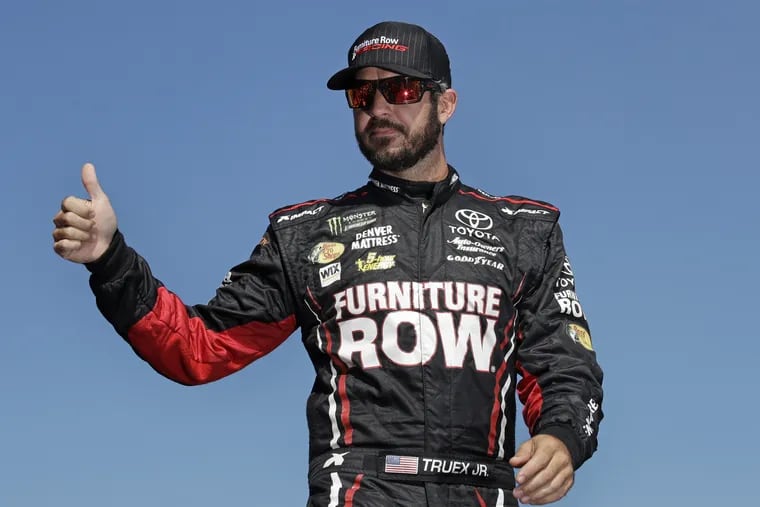 FILE – In this Sept. 24, 2017, file photo, Martin Truex Jr., the playoff point leader, flashes a thumb up as he is introduced prior to the NASCAR Cup Series 300 auto race at New Hampshire Motor Speedway in Loudon, N.H. Furniture Row Racing will cease operations at the end of this season, shutting its doors one year after Martin Truex Jr. won NASCAR's championship driving for the maverick race team. Furniture Row is an anomaly in NASCAR in that it is a single-car team based in Denver, Colorado, far removed from the North Carolina hub. Team owner Barney Visser was a racing enthusiast with a vision when he launched the team in 2005 determined to do it his own way. But a lack of sponsorship for next season led Visser to make the "painful decision" to close the team. (AP Photo/Charles Krupa, File)