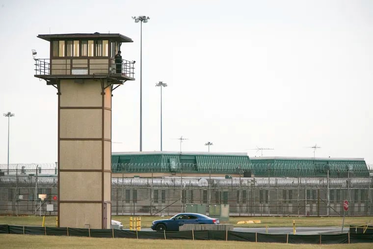FILE - In this Feb. 1, 2017, file photo, a prison guard stands on a tower during a hostage situation at James T. Vaughn Correctional Center in Smyrna, Del. (Suchat Pederson / The News Journal via AP, File)