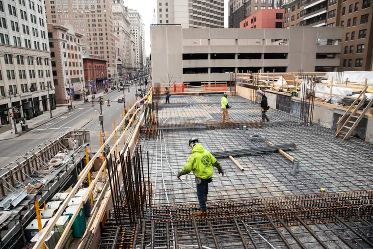 Construction workers work on the pool on the sixth floor of the under construction Arthaus building in Philadelphia, Pa. on Monday, February 15, 2021. Carl Dranoff, CEO of Dranoff Properties, said that the first occupants will move into the building in February 2022.
