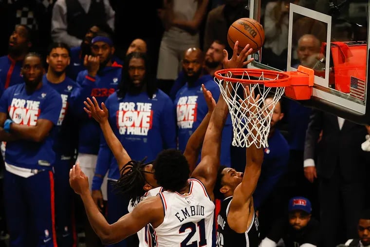 Sixers center Joel Embiid blocks Brooklyn Nets guard Spencer Dinwiddie’s layup attempt during Game 3 in the first round of the playoffs on April 20.