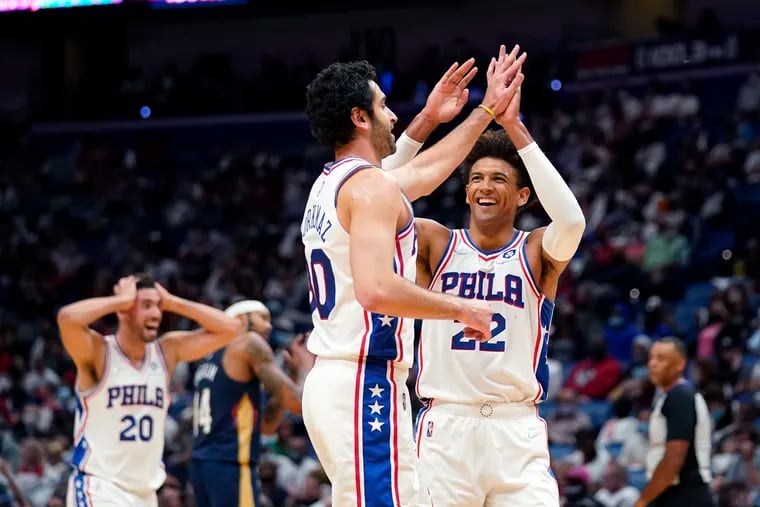 76ers guard Furkan Korkmaz celebrates his three-pointer with Matisse Thybulle (22) and forward Georges Niang (20) in the second half Wednesday in New Orleans.