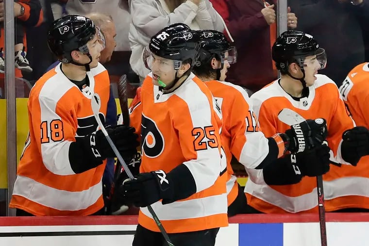 Flyers left winger James van Riemsdyk (25), shown celebrating  his goal with his teammates against Florida on Feb. 10, will be healthy and ready to return to the lineup if the season resumes.