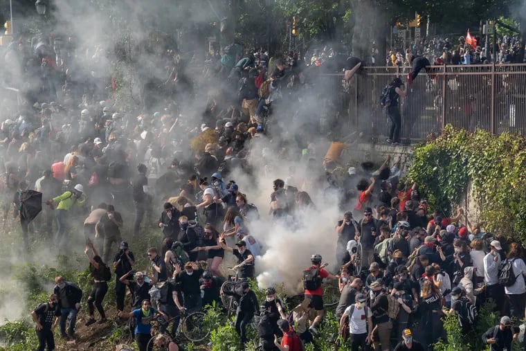 Police fire tear gas at protesters on I-676 on June 1, 2020.