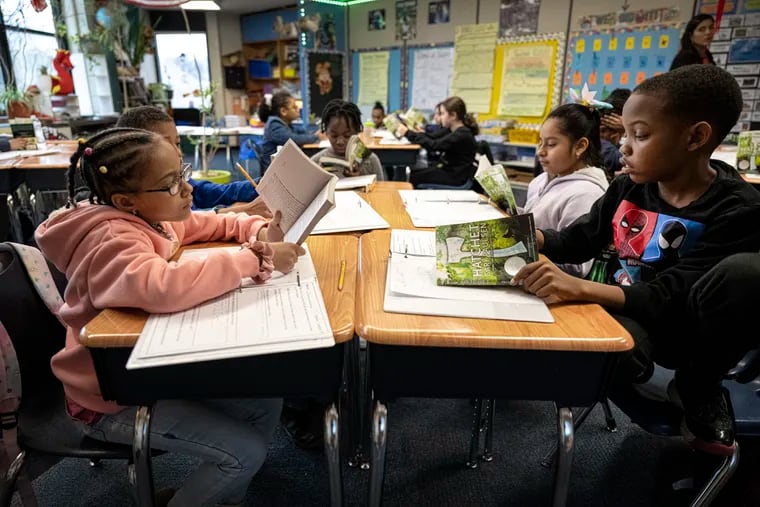 Fourth grade students, Cheyenne Wise, left, and Josiah Forney, read a book on Tuesday, Jan 30, 2024, during a reading class at the Hancock Elementary School in Norristown, Pa.