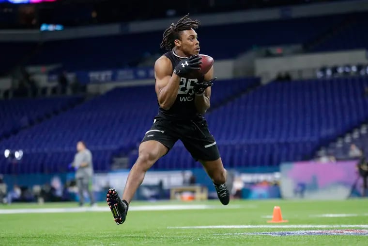 LSU wide receiver Justin Jefferson, shown catching a pass at the NFL scouting combine in late February, could be the Eagles' first-round selection in the draft Thursday night.
