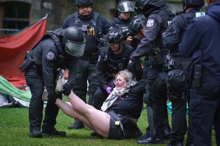 Police arrest a protester on the University of Pennsylvania campus in Philadelphia Friday morning.