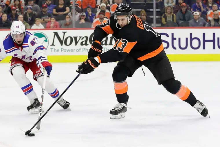 Flyers center Kevin Hayes (13) going after the puck against Rangers center Mika Zibanejad in a Dec. 23 game. Hayes, facing his ex-team, and Travis Sanheim had two goals in the Flyers' 5-1 win.