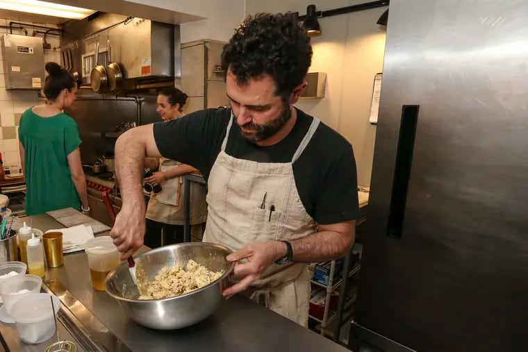 Chef-owner Ari Miller working in the kitchen of Musi in May 2019 shortly after its opening at Front and Morris Streets.