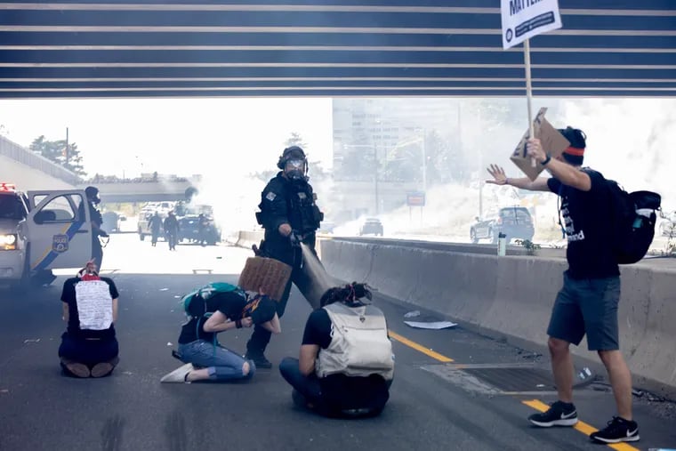 Philadelphia SWAT officer Richard P. Nicoletti shown pepper spraying three kneeling protesters on I-676 on June 1. Nicoletti is now being charged with simple assault, reckless endangerment, official oppression, and possession of an instrument of crime.