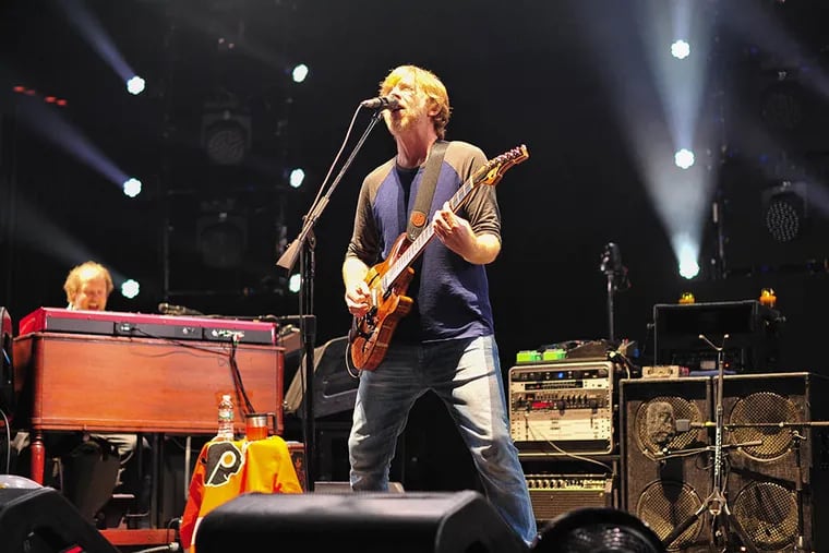 Page McConnell is on keyboards and vocals (left), and guitarist Trey Anastasio sings during the Phish Summer 2015 tour at the Mann Center. The band will pay three shows on the Atlantic City beach in August.