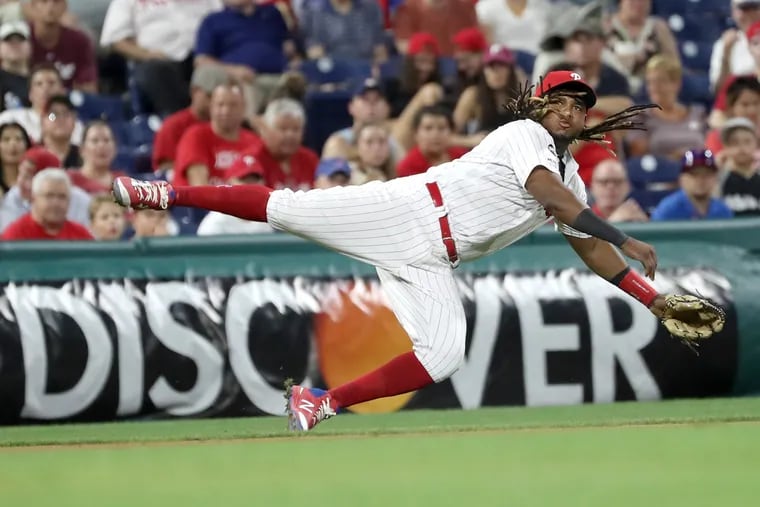 Maikel Franco flies through the air to make a play on Saturday.