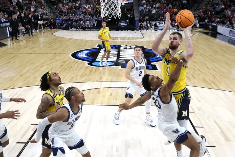 Hunter Dickinson of Michigan goes up for a basket against Jermaine Samuels of Villanova during the NCAA Tournament on March 24, 2022.